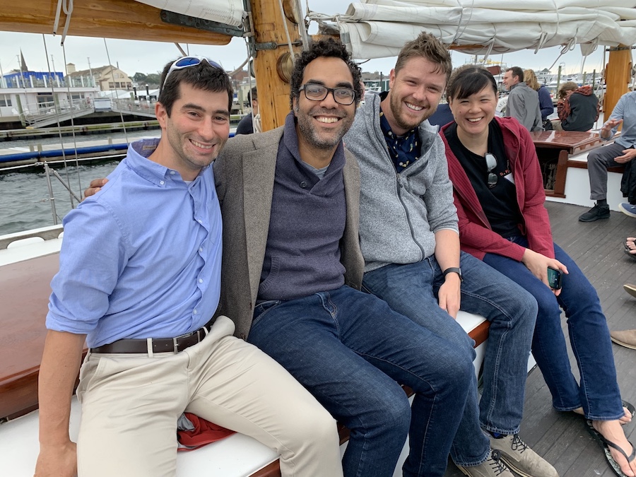 Residents seated on boat deck in harbor