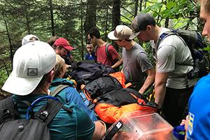 Fellows in the Wilderness and Austere Medicine Fellowship practice removing patients from the forest.