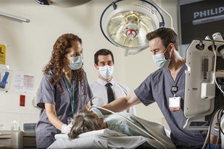 Emergency medicine physicians performing a neck anatomy evaluation
