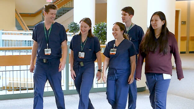 2024 Otolaryngology residents walking down hall at Dartmouth Hitchcock Medical Center