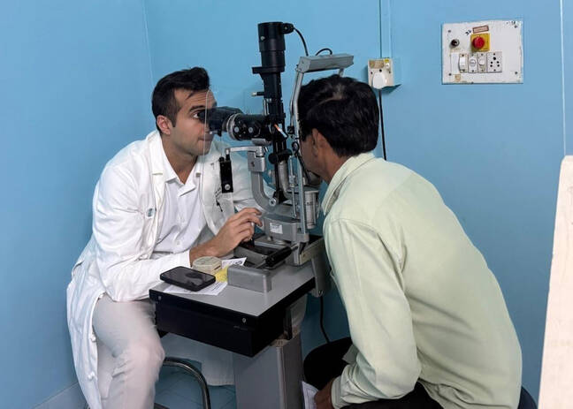 Divy Mehra examining a patient in Prasanthigram, India